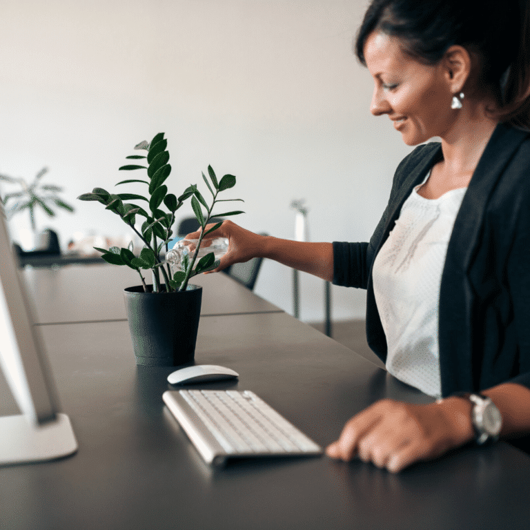 woman watering an office plant