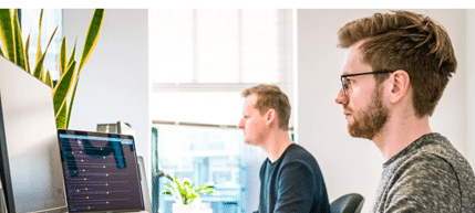 Workers looking at computer screen